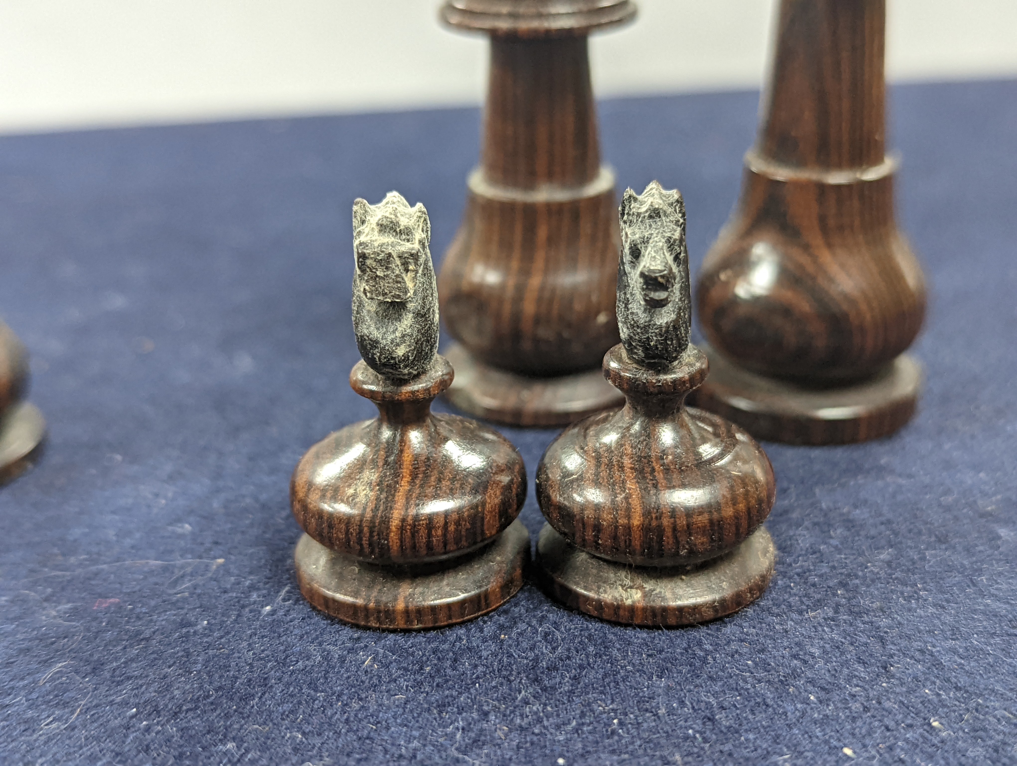 A Victorian brass inset mahogany games box, fitted with solitaire, cribbage, chessmen, draughts etc., 33cm, a turned and stained bone chess set, another games box containing chessmen and draughts
